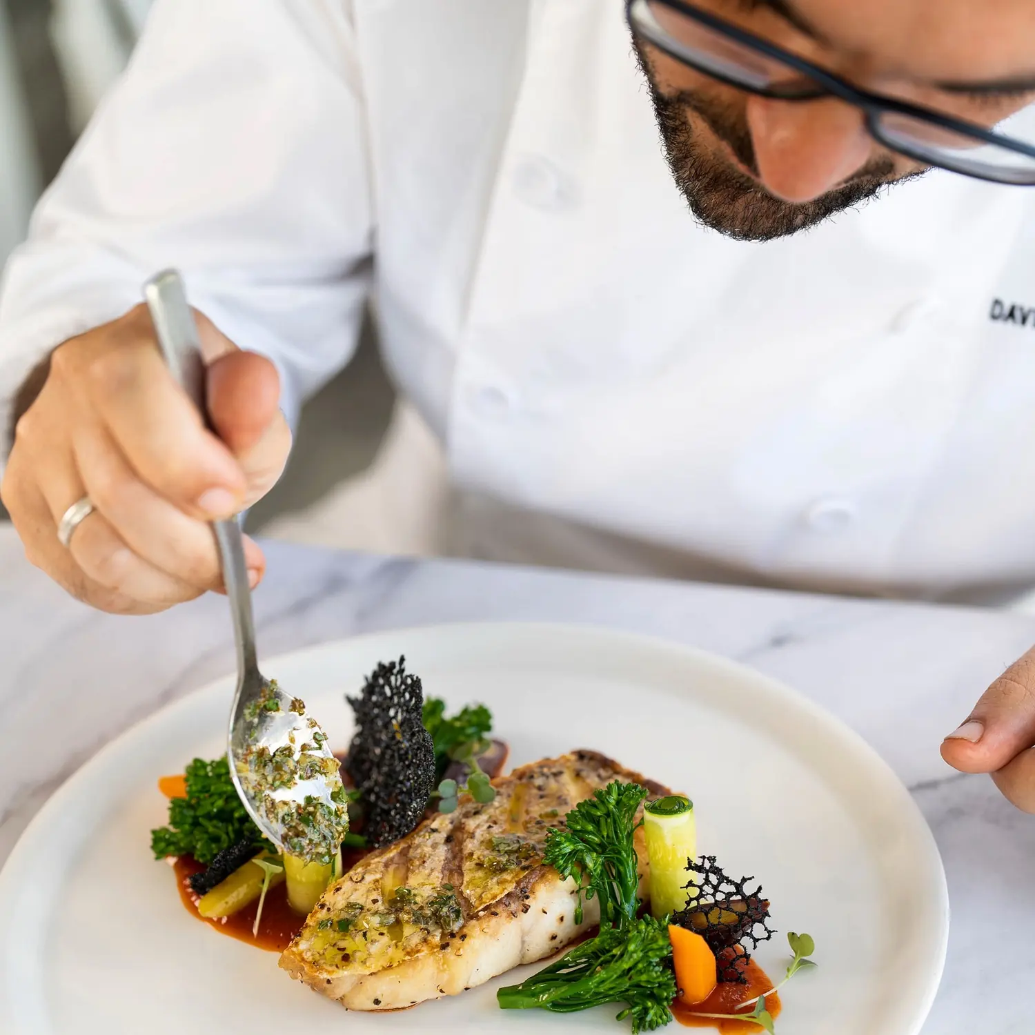 Davide finishing a fish dish